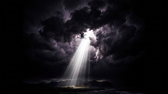 Dramatic divine light rays breaking through dark storm clouds over a mountain landscape