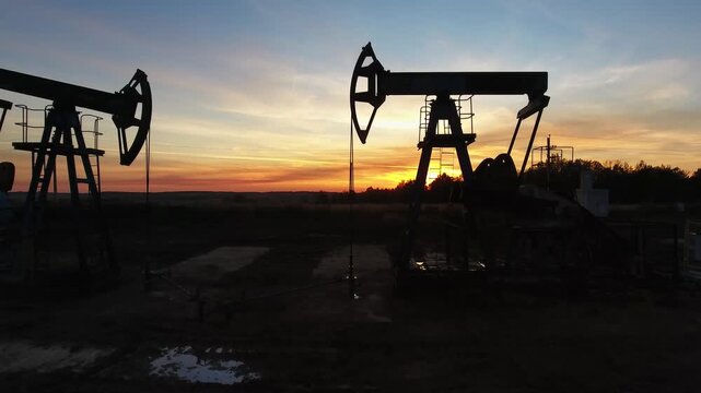 Aerial view of oil pumpjacks at sunset in Russia.