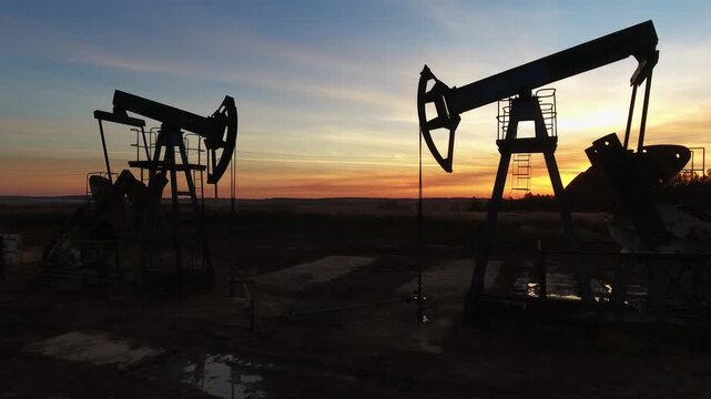 Aerial view of oil pumpjacks at sunset in Russia.