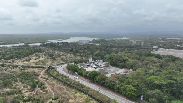 Aerial view of winding road and industrial area in Indonesia.