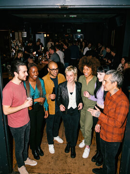 Seven friends arrive at a lively nightlife bar gathering