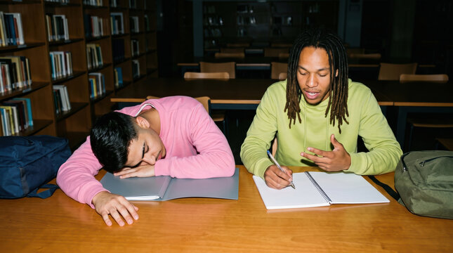 Student searching along a library bookshelf