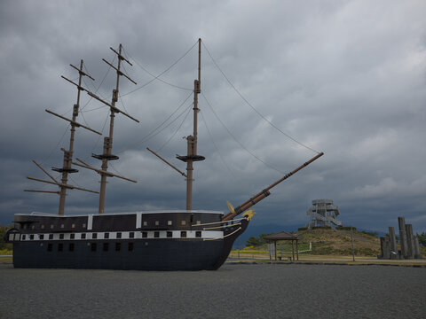 A replica sailing galleon monument on the grass by the coast, Japan