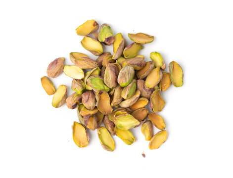 Fried salt pistachio nuts isolated. Baked pistachios pile, roasted green pistache fruits on white