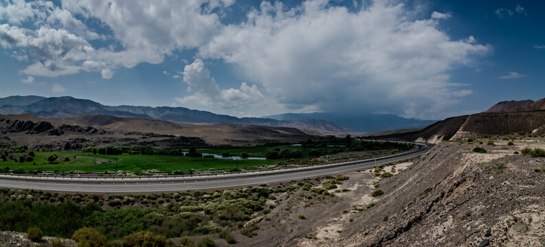 Wide valley highway and dramatic clouds along the road to Bishkek Kyrgyzstan