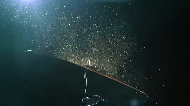 Super Slow Motion Shot of Cymbal Hit With Golden Glittering Particles at 1000fps.