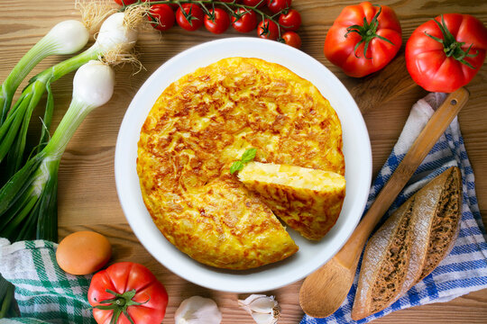 Spanish potato omelet tapa with a slice cut out. Top-down view. 