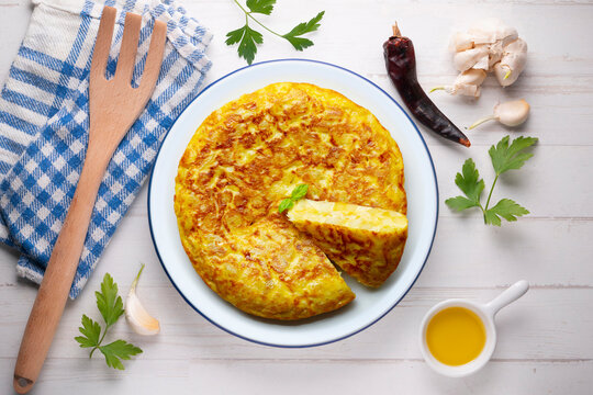 Spanish potato omelet tapa with a slice cut out. Top-down view. 