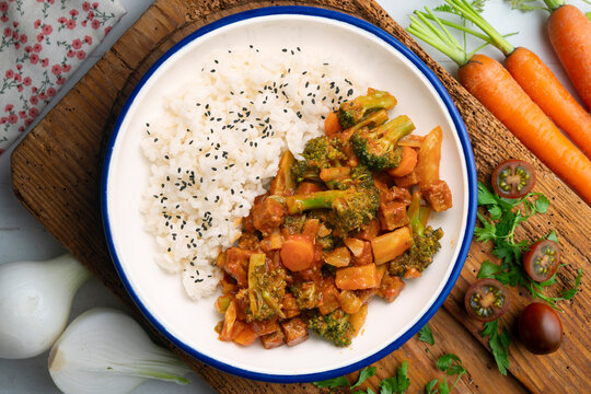 Vegetable and crispy tofu stew served with white rice. Top-down view. Traditional Christmas recipe.