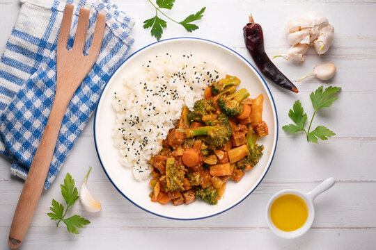 Vegetable and crispy tofu stew served with white rice. Top-down view. Traditional Christmas recipe.