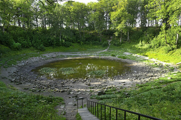 The largest impact crater at Kaali on the Estonian island of Saaremaa, formed by a meteorite impact. The explosion that created the crater occurred approximately 660 ± 85 BC. © Pecold
