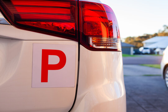 Red p plate on car parked on driveway