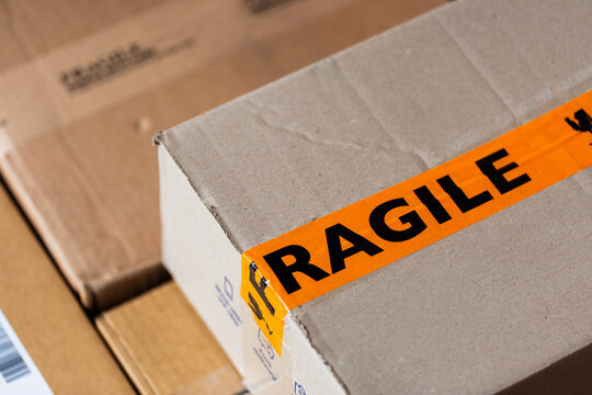 Cardboard boxes piled outside door of house from online home delivery orders