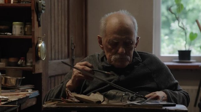 Elderly craftsman working in his old workshop, carefully restoring collectible Japanese bladed weapons