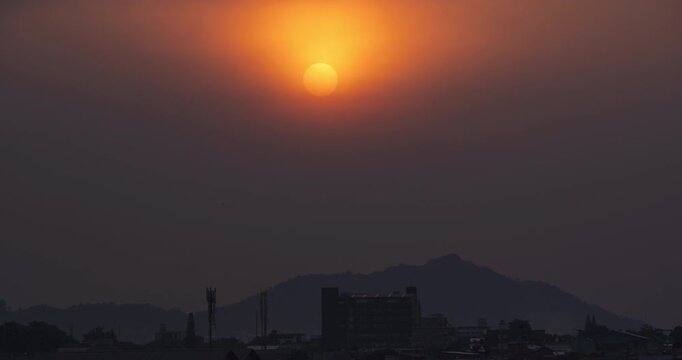 Timelapse of the sun setting behind thick air pollution