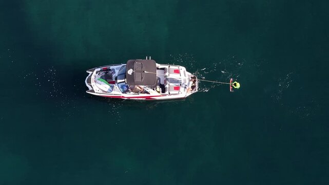 Aerial view of a boat towing a wakeboarder in Vallauris, France.