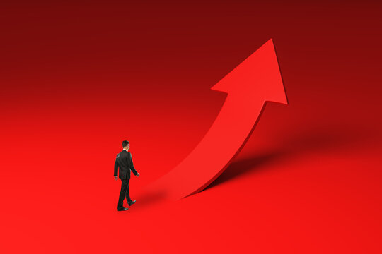 Businessman Walking Toward a Giant Upward Arrow for Growth, Success, Career Progress, Breakthrough, and Corporate Ambition on Red Background.