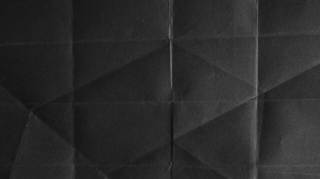 Black paper texture with geometric fold lines and creases background