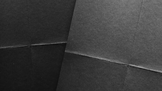 Dark black paper texture with creases and fold lines background
