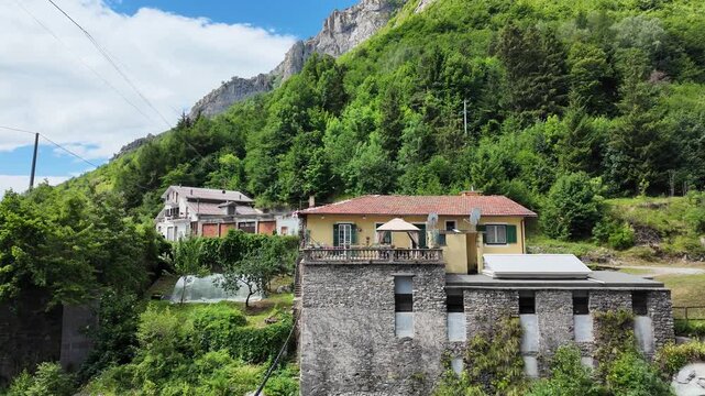 4K footage, a panoramic view of a mountain village and its valley in the Alpine Piedmont region of Upega&mdash;near Ormea&mdash;during the summer months. Ideal for travel guides and mountain vacations.