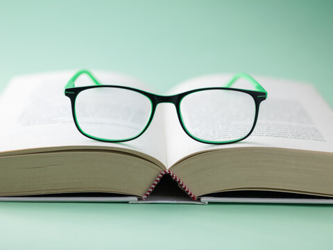 Frontal View of Eyeglasses on Open Hardcover Book