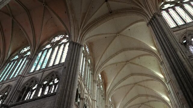 Gothic cathedral interior with vaulted ceiling and tall windows in Amiens France
