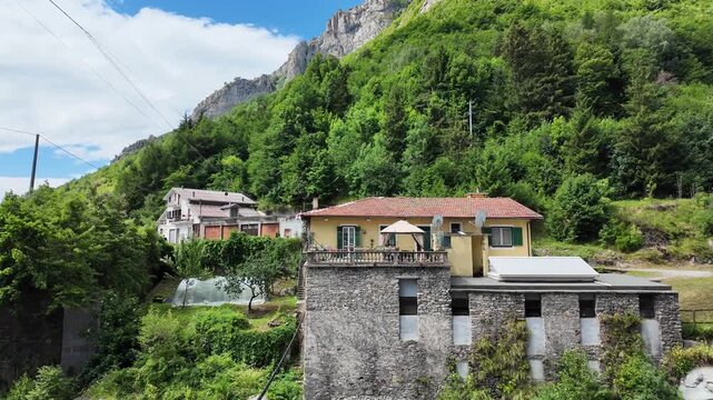 Piedmontese mountain landscape at Colle di Nava with an alpine stream in the background on a cool summer day.