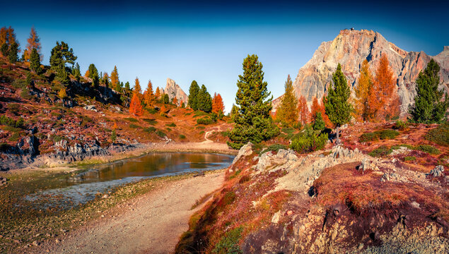 Astonishing morning view of frozen Limides lake. Awesome autumn landscape of Dolomite Alps. Fabulous outdoor scene of Falzarego pass, Italy, Europe. Beauty of nature concept background.