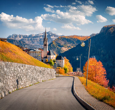 Marvelous autumn cityscape of Pieve village,  Province of Belluno, Italy, Europe. Exciting morning scene of Parrocchia di San Giacomo Maggiore Catholic church with huge Alps peak on background. 