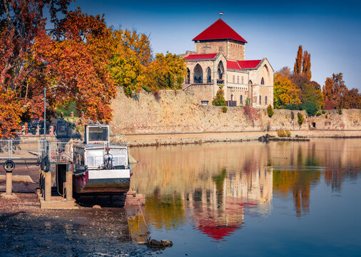 Colorful autumn view of Tata Castle - 14th-century castle and museum with restored rooms and garden. Breathtaking morning cityscape of Tata town on the shore of Tatai lake, Hungary, Europe.