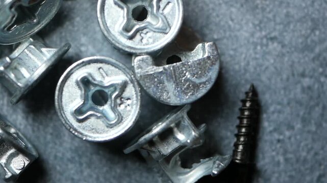 Close up top view of metal screw parts and hardware tools slowly rotating, industrial and mechanical components for construction