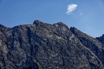 Fototapeta premium Mountain View Through Alpine Forest Framed by Dramatic Cloudy Sky Near Zugspitze