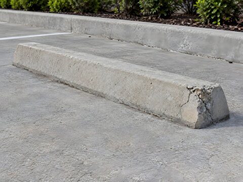 Chipped Concrete Parking Wheel Stop Requiring Repair