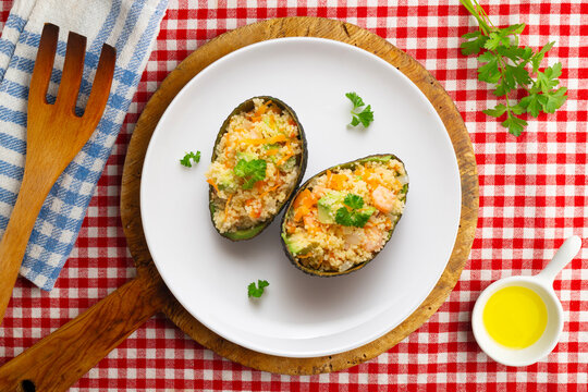 Avocados stuffed with couscous and vegetables. Overhead view of the table. 