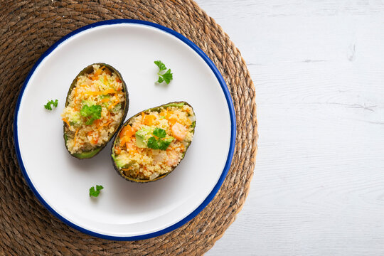 Avocados stuffed with couscous and vegetables. Overhead view of the table. 