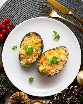 Avocados stuffed with couscous and vegetables. Overhead view of the table. Recipe for celebrating Christmas.