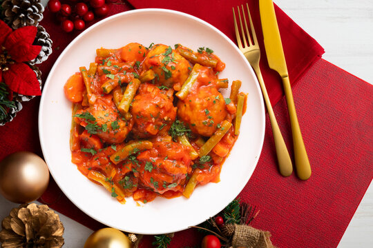 Meatballs with tomato and vegetable sauce. Overhead view of the table. Recipe for celebrating Christmas.