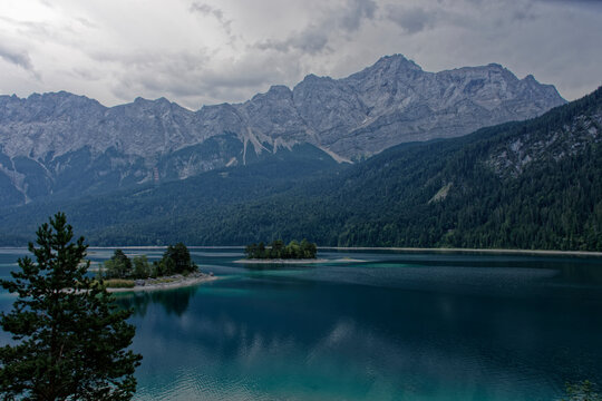 Turquoise Waters and Islands of Lake Eibsee Beneath Zugspitze Mountain Peak