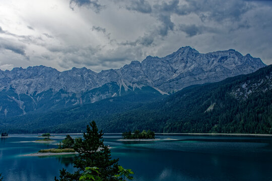 Turquoise Waters and Islands of Lake Eibsee Beneath Zugspitze Mountain Peak