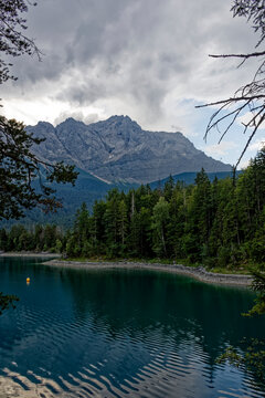Turquoise Waters and Islands of Lake Eibsee Beneath Zugspitze Mountain Peak