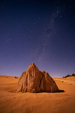 View of The Pinnacles Desert limestone formation under a starry night sky with the Milky Way visible in the desert landscape of Cervantes, Western Australia, Australia.