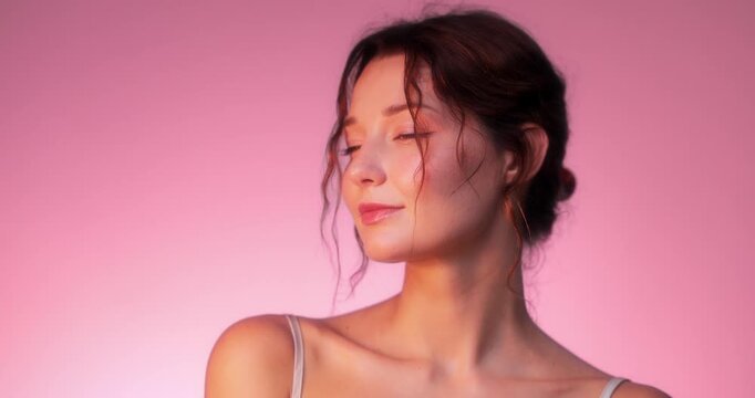 Elegant Woman Posing In Soft Pink Light With Romantic Expression