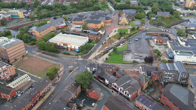 Aerial video featuring the King Street Tram Stop in Oldham, Greater Manchester with Metrolink Tram Passing in the morning. 