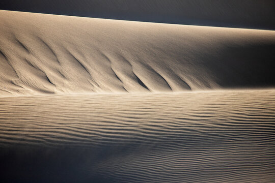 View of the Lancelin Sand Dunes with wind-blown sand patterns and soft light in Lancelin, Western Australia, Australia.