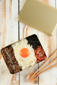 Korean Dosirak Lunchbox with Kimchi, Bulgogi Beef, Seaweed, Rice, and Sunny Side Egg.