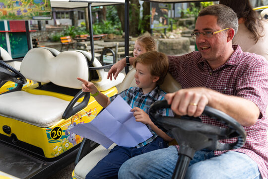 Family enjoying theme park ride.