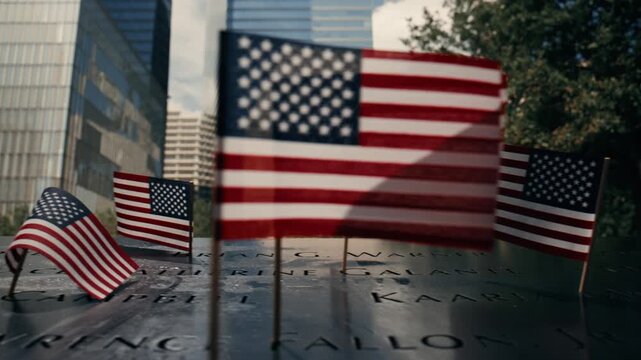 American flags at September 11 memorial reflecting pool