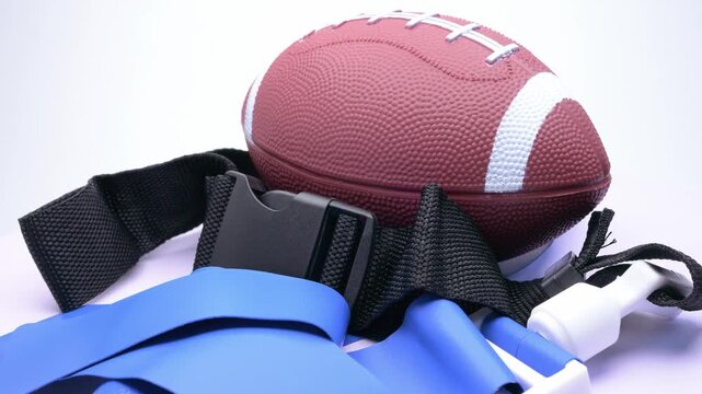 Flag football gear set with american football and blue flag belts rotating