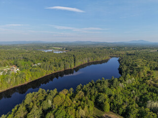 Obraz premium Aerial View of Stumpfield flowage in Hopkinton, NH Through Dense Forest and Lakes Under a Clear Blue Sky