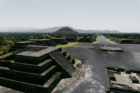 View of the ancient pyramids and the Avenue of the Dead at the Teotihuacan archaeological site with stone structures and mountains in Teotihuacan de Arista, Estado de Mexico, Mexico.